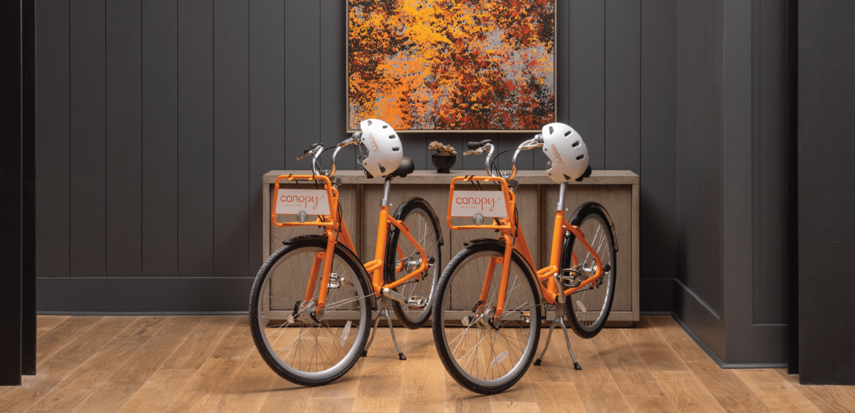 Two orange Canopy by Hilton Bicycles and bike helmets