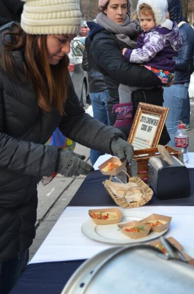 person serving samples of chowder